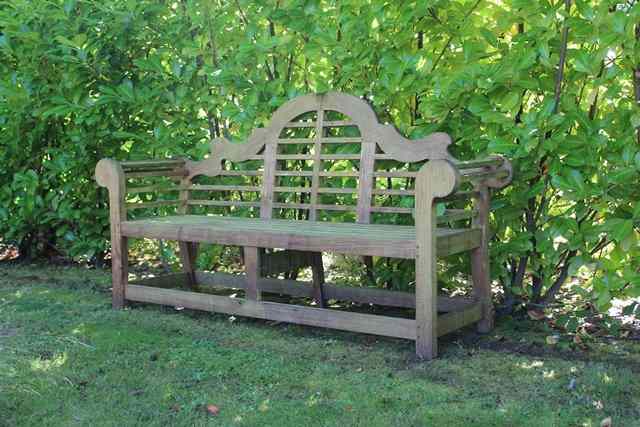 Appraisal: A TEAK LUTYENS STYLE GARDEN SEAT with camel back and