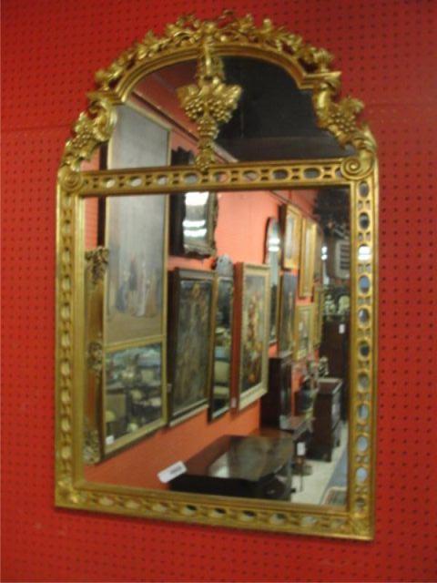 Appraisal: Giltwood Mirror with Ribbon Crown Grapes and Fretwork frame From