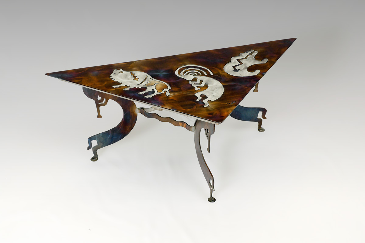 Appraisal: SOUTHWEST KOKOPELLI MOTIF METAL COFFEE TABLE Triangular acid and heat