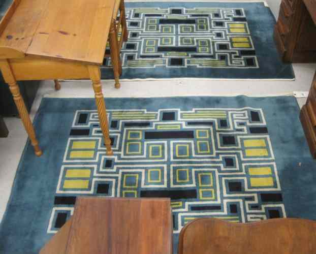 Appraisal: A DECORATIVE PAIR OF CONTEMPORARY NEPALI AREA RUGS featuring a