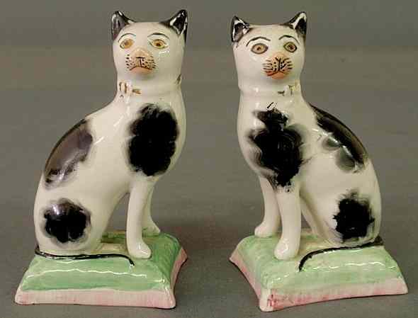 Appraisal: Two small th c Staffordshire cats seated on green and