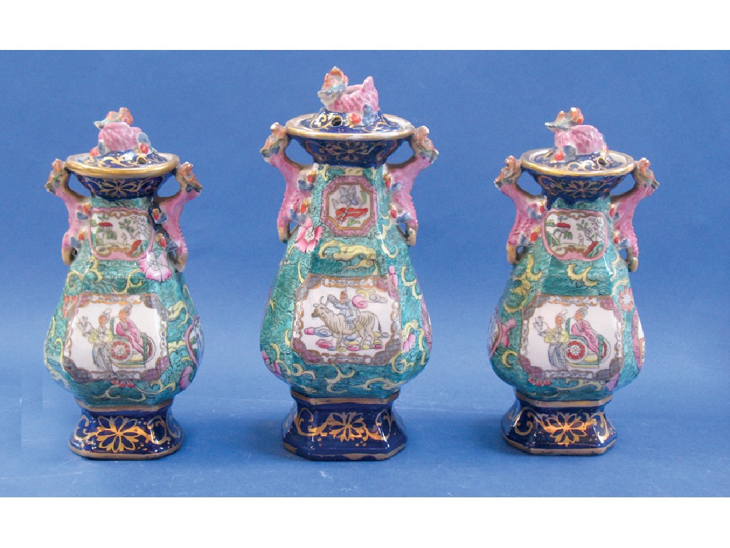 Appraisal: A TH CENTURY IRONSTONE GARNITURE of vases and covers each