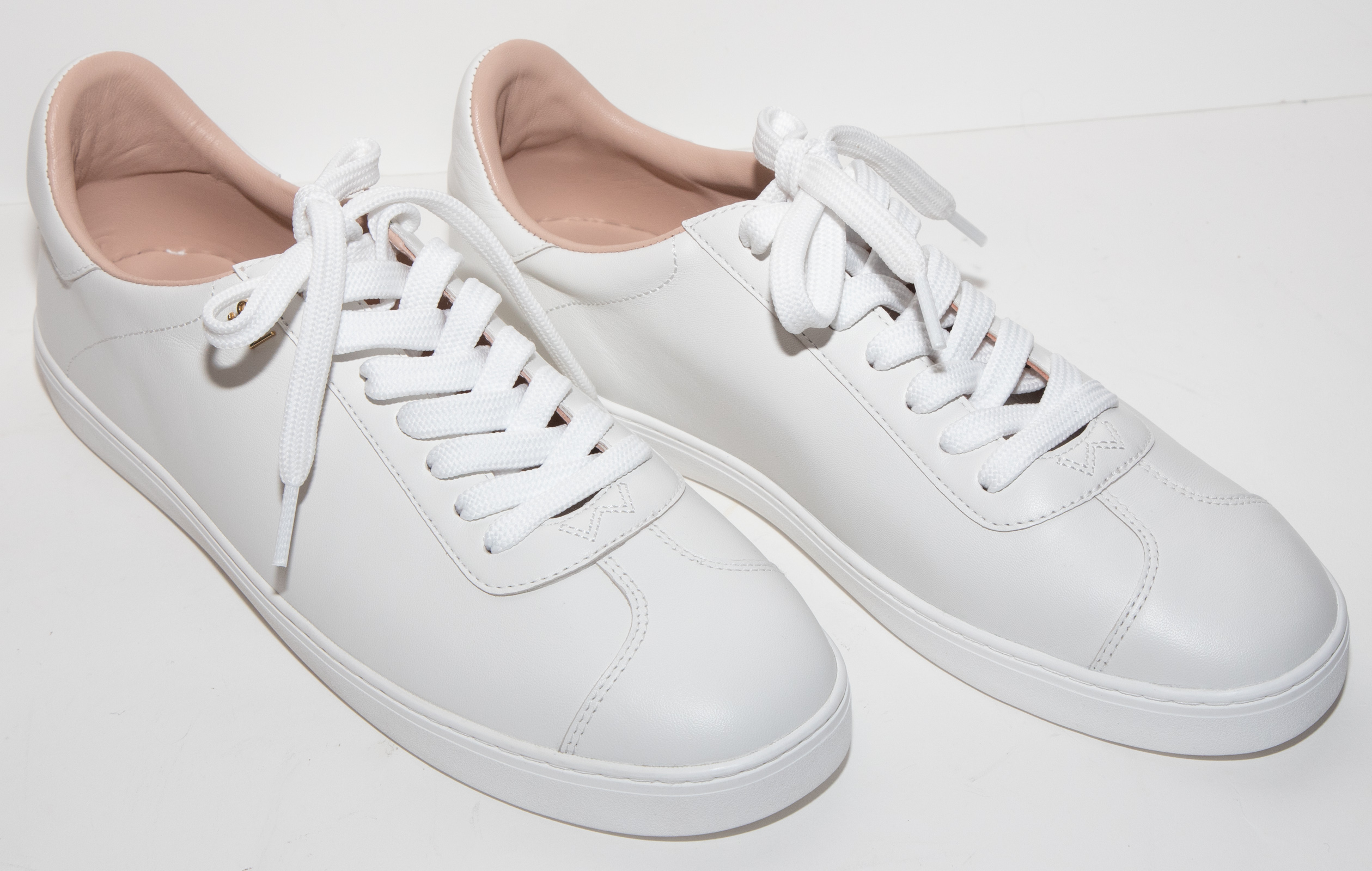 Appraisal: PAIR STUART WEITZMAN WHITE LEATHER CRISTY SNEAKERS size new in