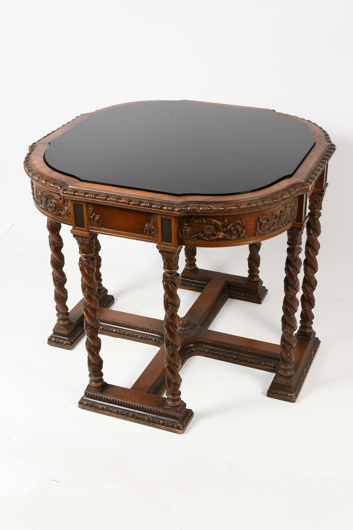 Appraisal: ORNATELY CARVED GLASS TOP PARLOR TABLE Black glass top over