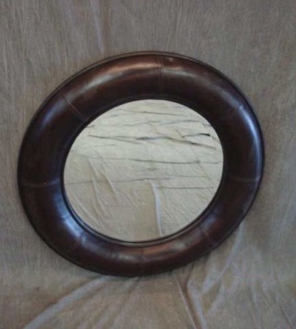 Appraisal: Round leather-framed mirror Dimensions diameter overall Estimate -