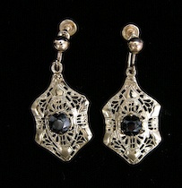 Appraisal: A Pair Of Gold Earrings With Round Cut Black Stones