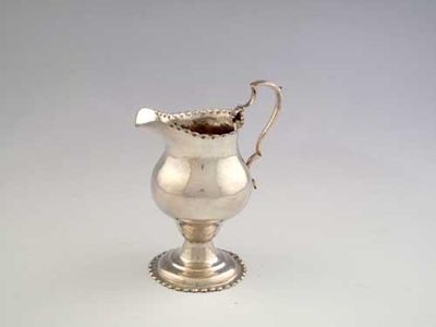 Appraisal: A George III baluster cream jug with punch beaded borders