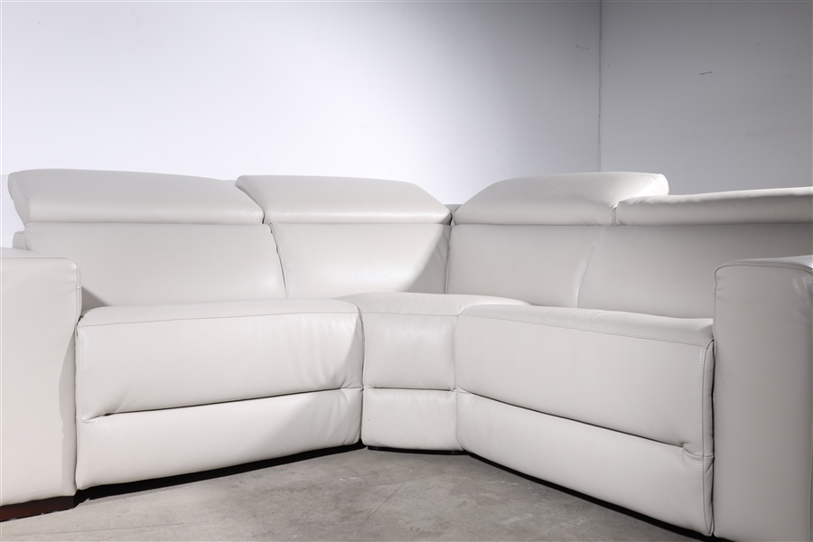 Appraisal: Three-piece wide eggshell leather vinyl sectional with armrest from right