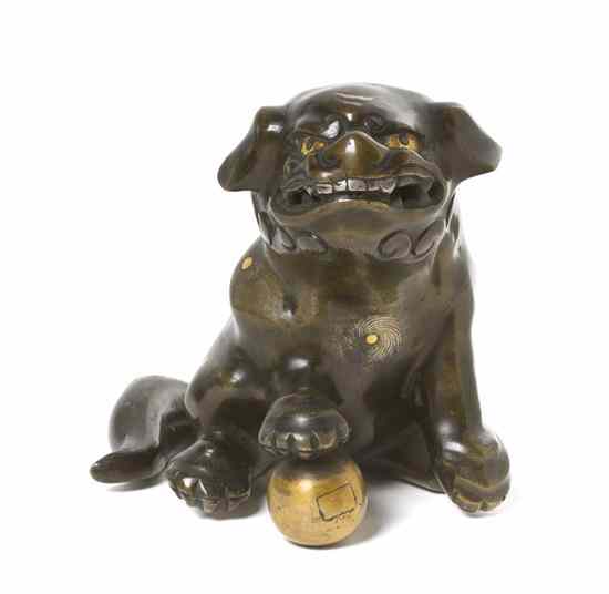 Appraisal: A Chinese Bronze Pup having gold spot accents and silver