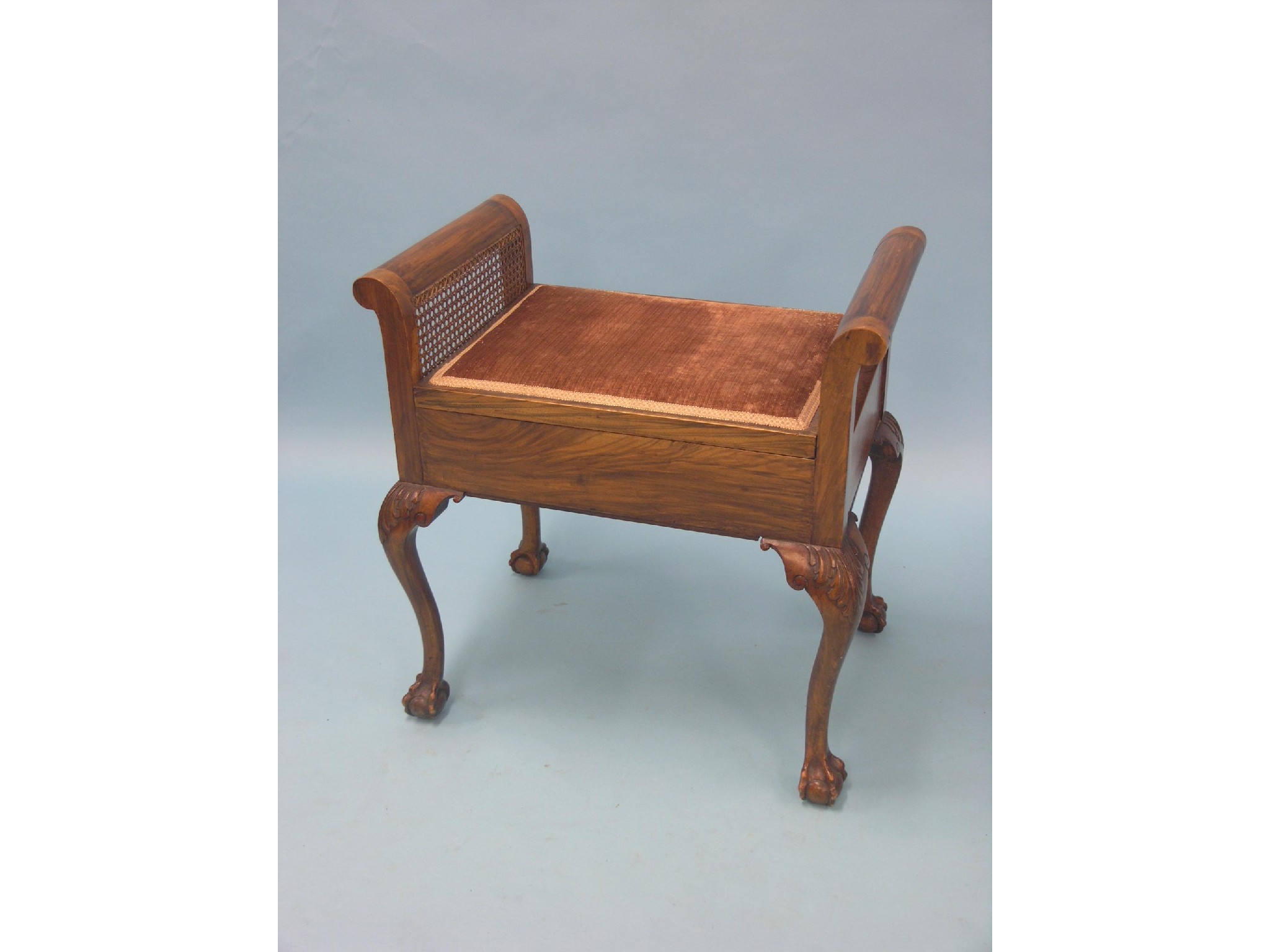 Appraisal: A grained walnut piano stool with hinged upholstered seat claw