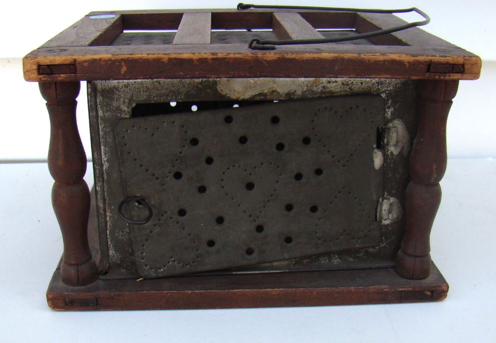 Appraisal: PIERCED TIN AND WOOD FOOT WARMER In red stain with