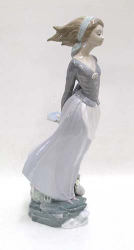 Appraisal: LLADRO PORCELAIN FIGURINE Sea Breeze wind blown girl with book