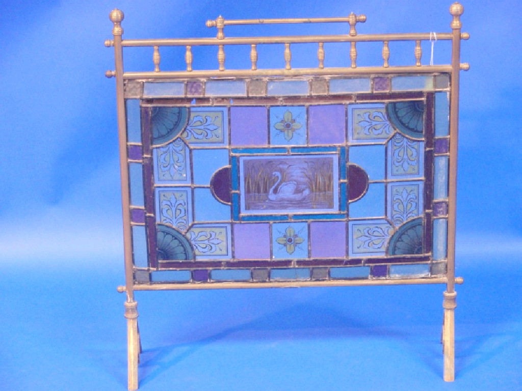 Appraisal: A Victorian brass framed fire screen with leaded stained glass