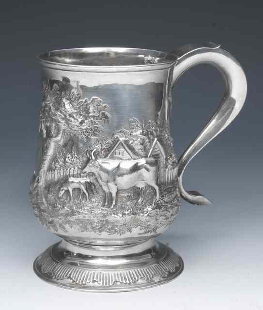 Appraisal: A GEORGE III SILVER TANKARD baluster shaped standing on a