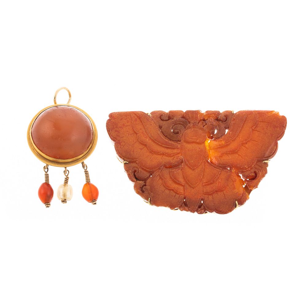 Appraisal: Two Amber Pendants in K K K yellow gold pendant