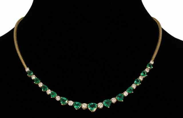 Appraisal: An emerald and diamond set ct yellow gold serpentine link