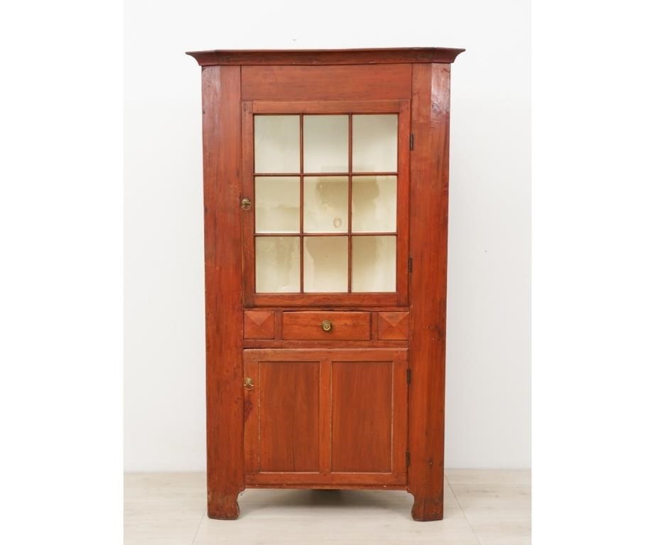 Appraisal: Pennsylvania one-piece painted corner cupboard circa in old red paint