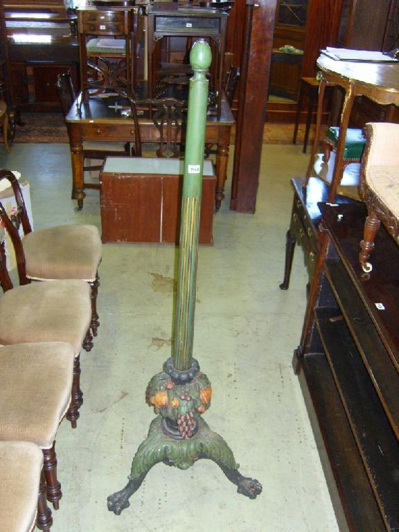 Appraisal: A carved lamp standard on a robust tripod base with