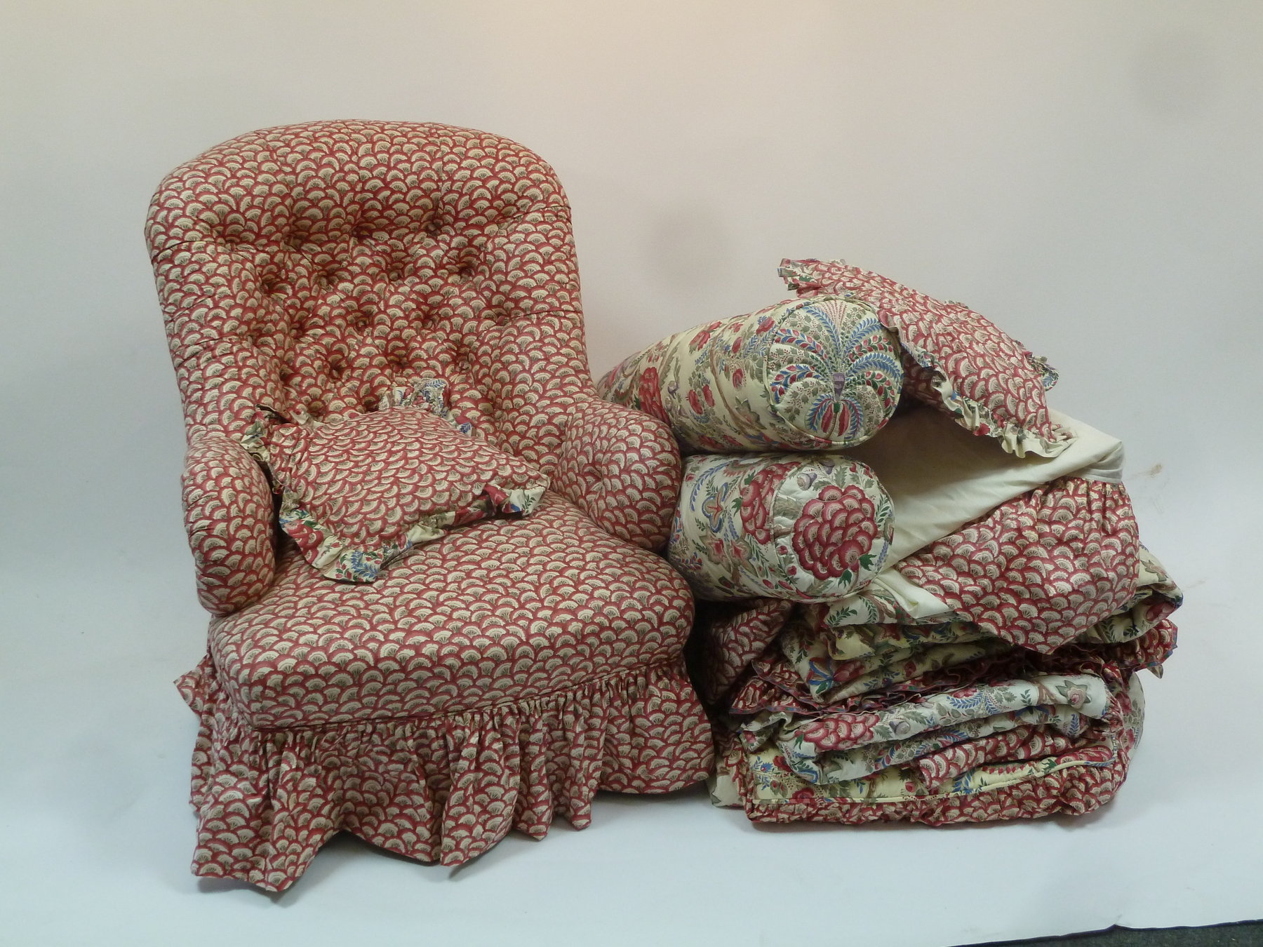 Appraisal: A button upholstered armchair on turned legs three cushions three