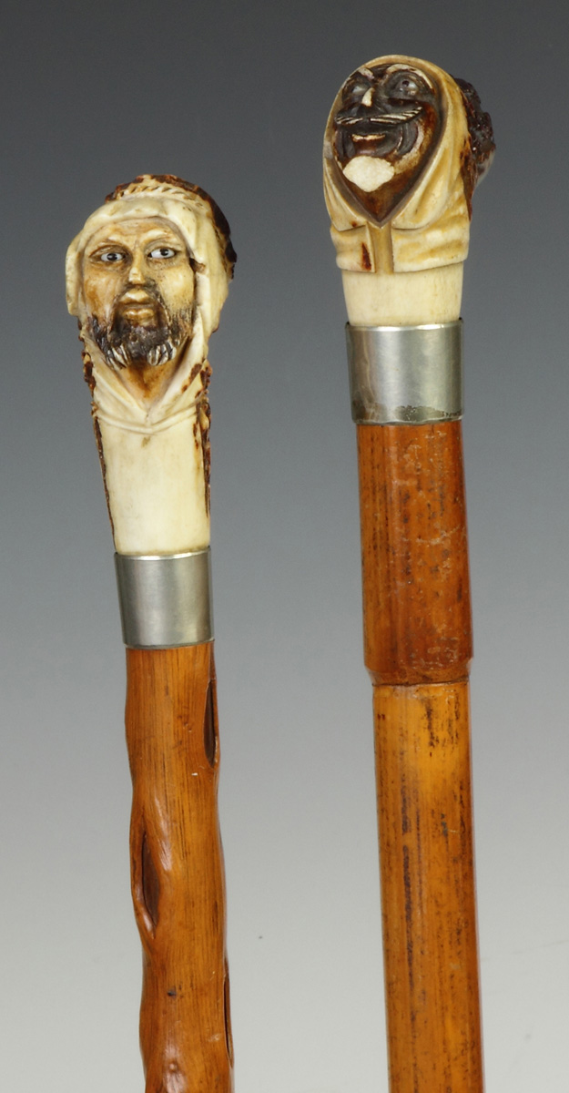 Appraisal: Two Wood Carved Horn Canes th cent Blown glass eyes