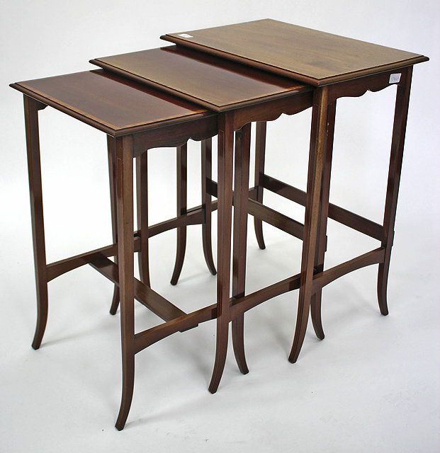 Appraisal: A NEST OF THREE MAHOGANY RECTANGULAR TOPPED OCCASIONAL TABLES with