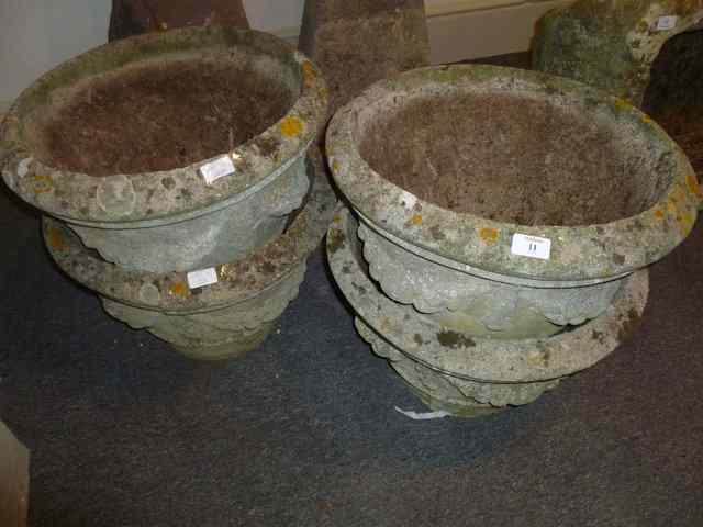 Appraisal: A SET OF FOUR COMPOSITE STONE GARDEN URNS each with