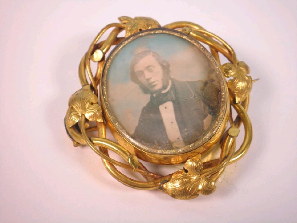 Appraisal: A large Victorian memorial brooch with photo portrait and hair