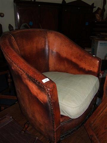 Appraisal: An Art Deco leather upholstered tub chair with pressed leather