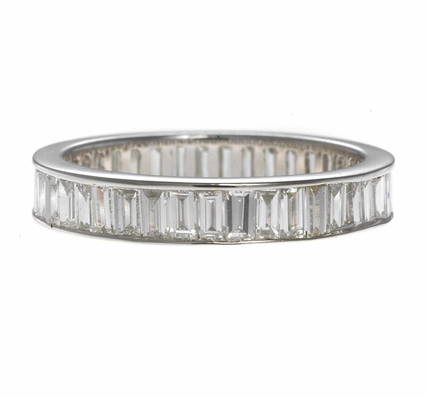 Appraisal: A diamond eternity band composed of baguette-cut diamonds estimated total