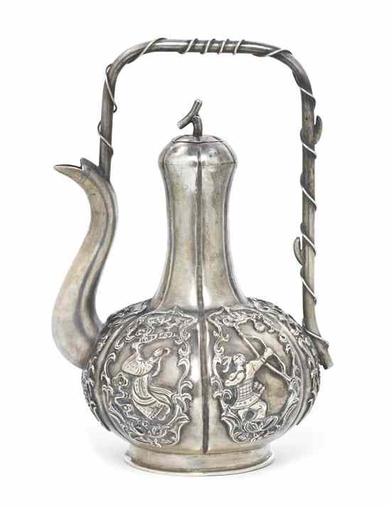 Appraisal: A Japanese Silver Teapot of lobed gourd form having raised