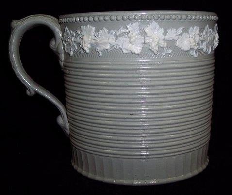 Appraisal: A salt glazed mug with ribbed decoration and C scroll