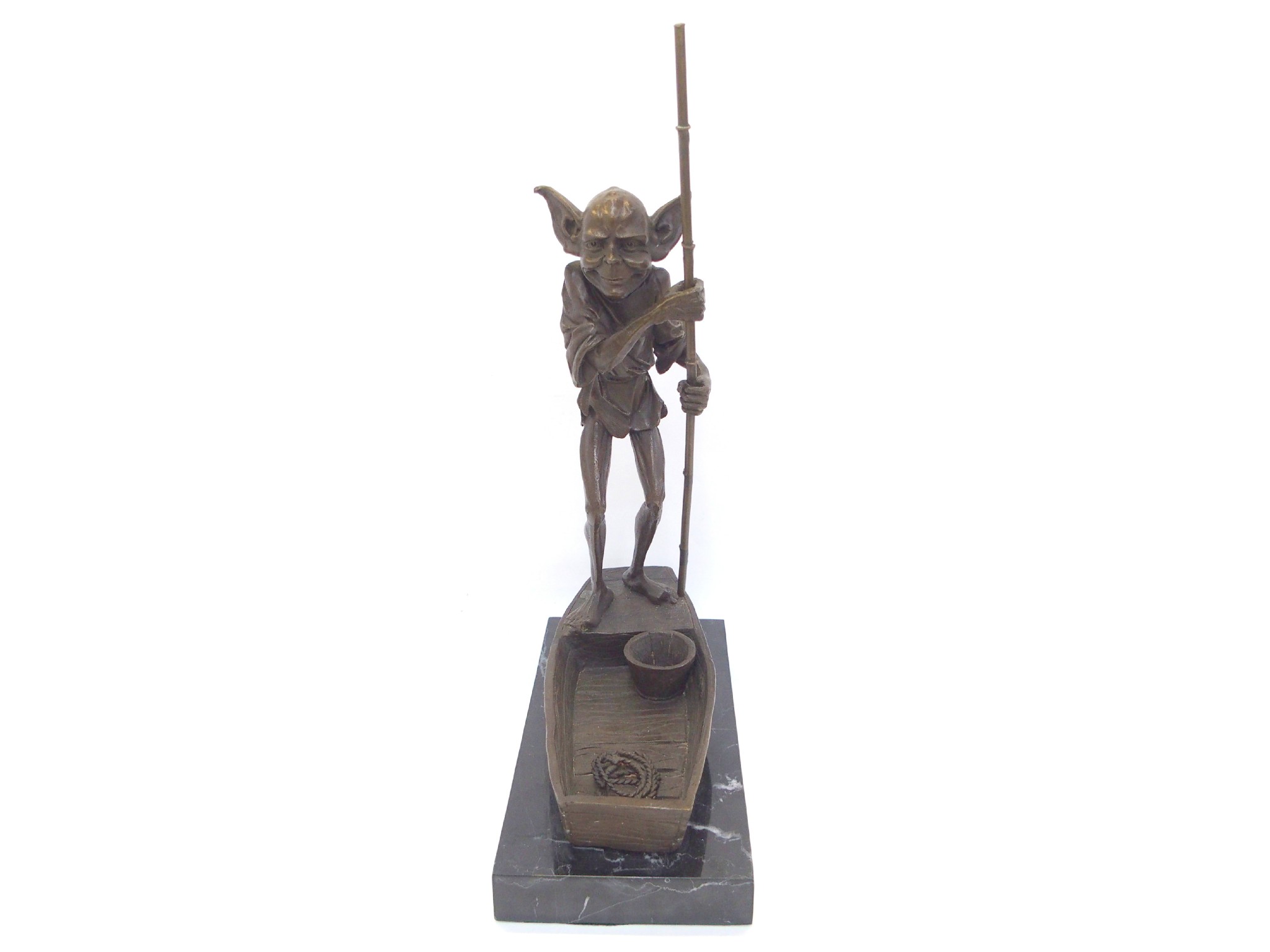 Appraisal: Bronzed metal figure of an imp in a boat upon