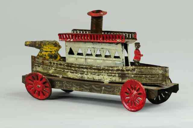 Appraisal: TIN GUN BOAT PULL TOY Stamped tin spoked wheels upper