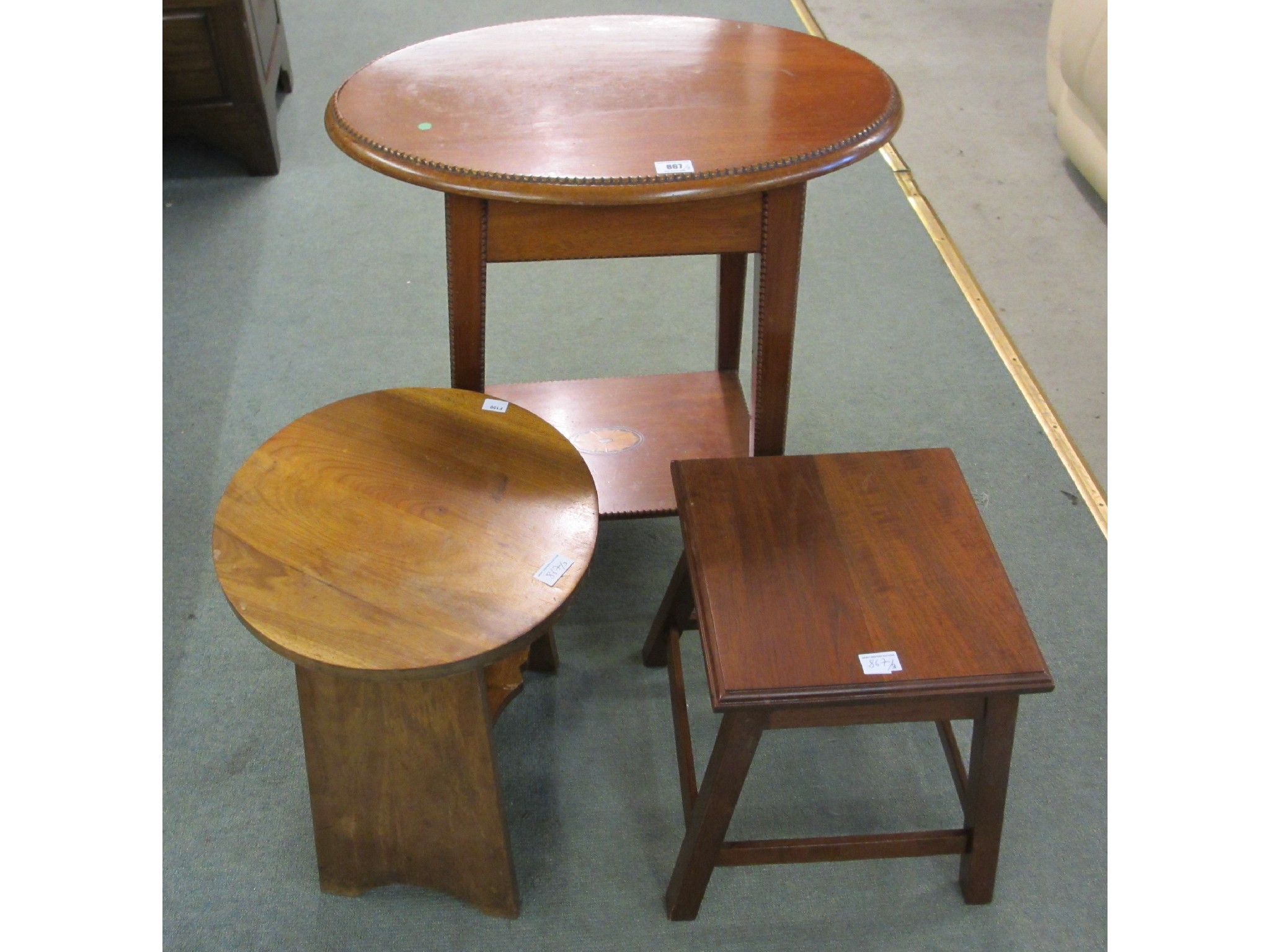 Appraisal: A mahogany oval occasional table square table and circular table