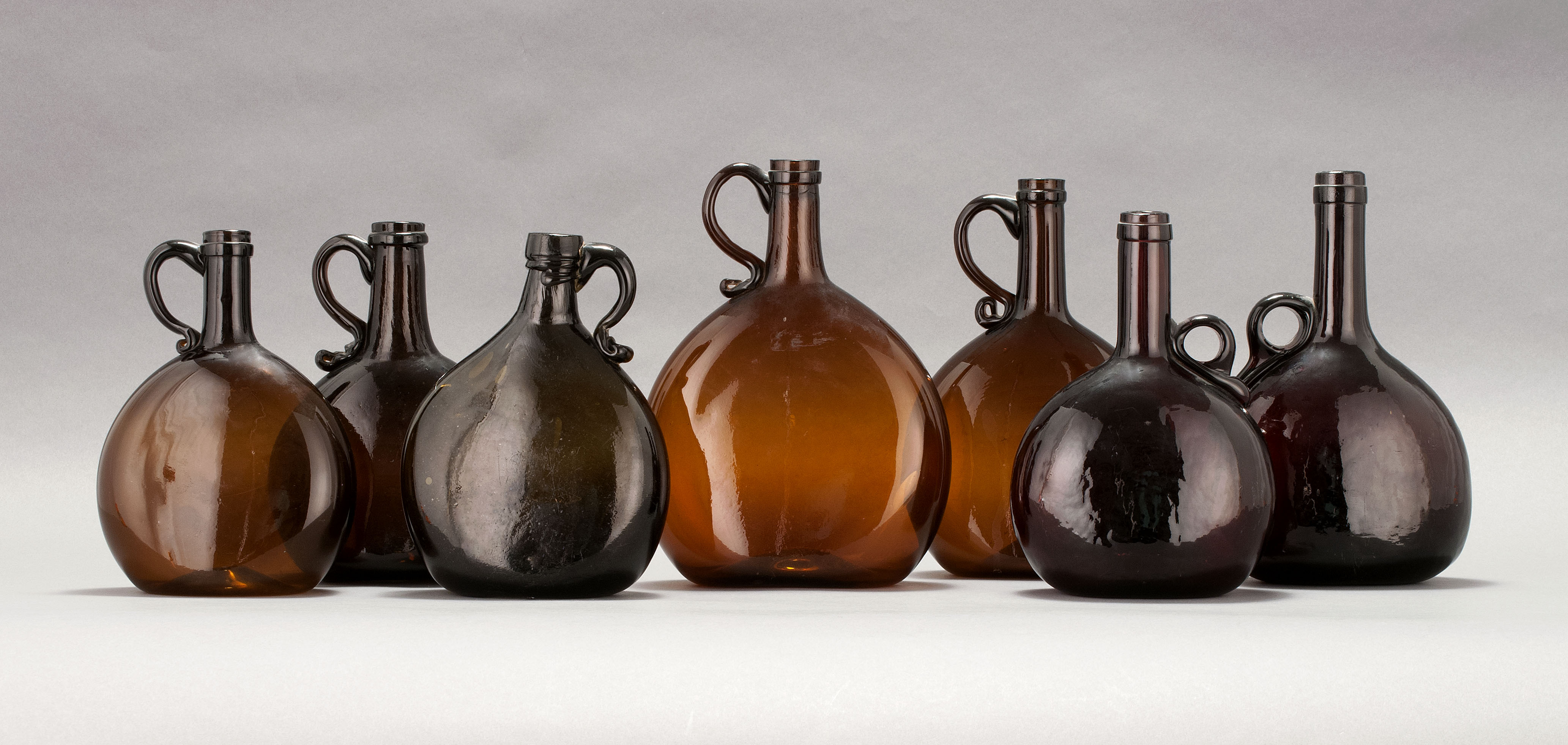 Appraisal: SEVEN BLOWN AND BLOWN-MOLDED GLASS BOTTLES th CenturyIn olive green