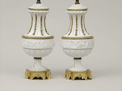 Appraisal: Pair of Louis XVI-Style Gilt-Metal Mounted Biscuit Porcelain Covered Urns