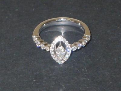 Appraisal: A MARQUISE DIAMOND RING the central marquise claw set within