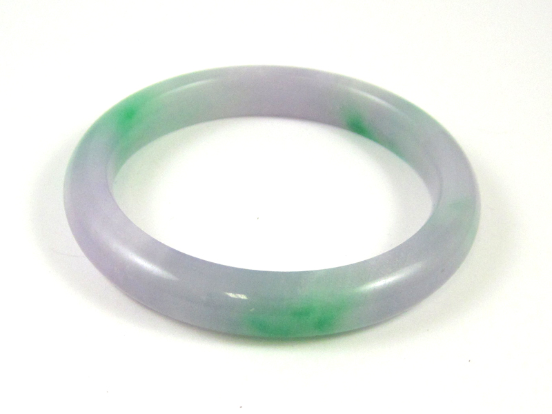 Appraisal: LAVENDER AND GREEN JADE BANGLE weighing grams and measuring mm