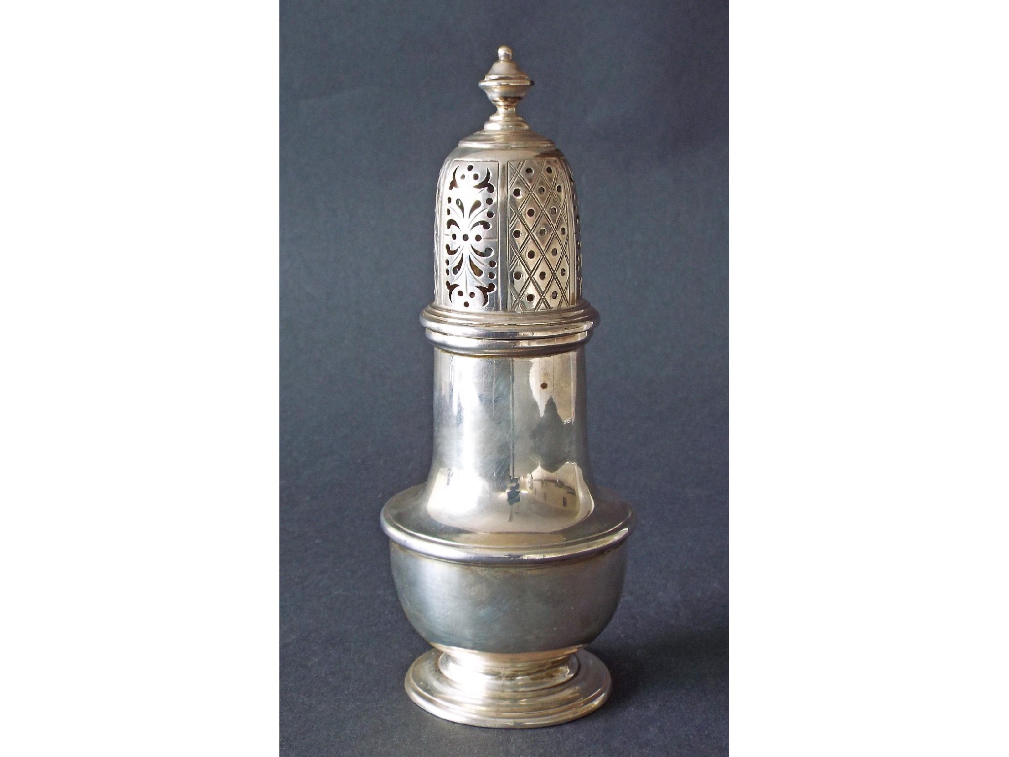 Appraisal: Georgian style silver baluster sifter the pierced lid with diaper