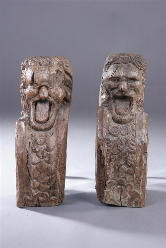 Appraisal: PAIR CARVED WOOD GROTESQUE FRAGMENTS th th century Weathered deep-cut