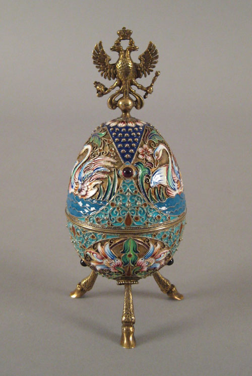 Appraisal: Russian silver gilt and enamel egg ca with swan decoration