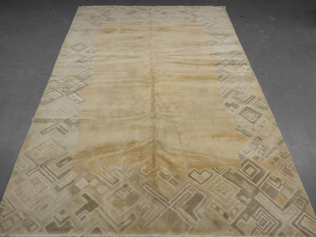 Appraisal: OVERSIZE TIBETAN CONTEMPORARY RUG Tibet th CenturyOpen cream field surrounded