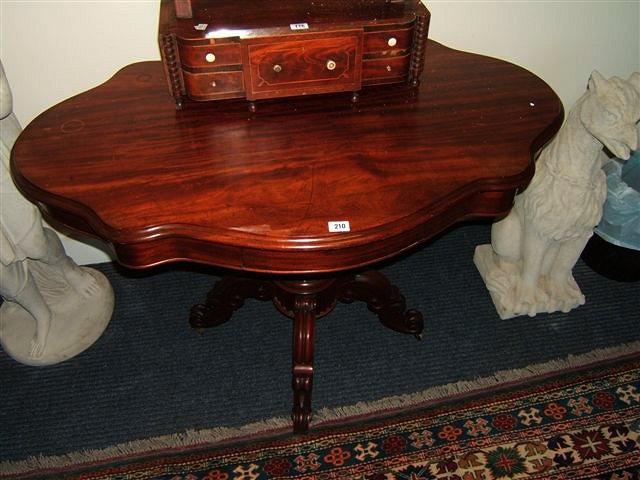 Appraisal: A th Century French mahogany table with serpentine top baluster