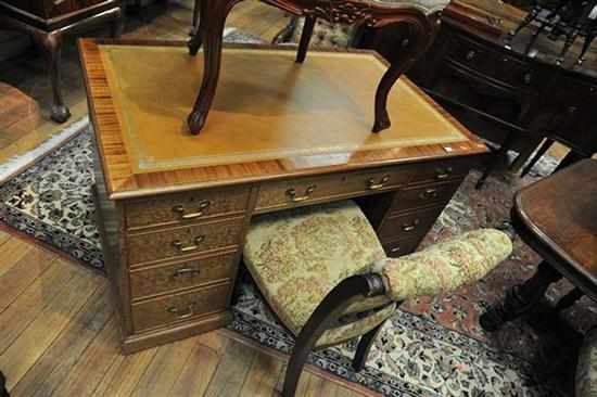 Appraisal: A VICTORIAN STYLE NINE DRAWER DESK WITH LEATHER INSET TOP