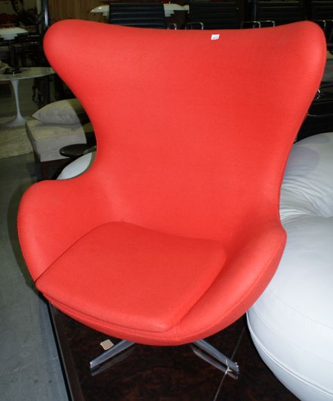 Appraisal: A red woolen fabric upholstered egg chair hand stiched to