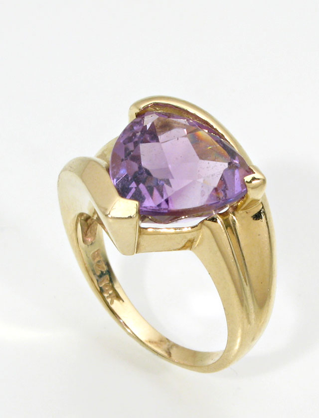 Appraisal: AMETHYST AND FOURTEEN KARAT GOLD SOLITAIRE RING featuring a large