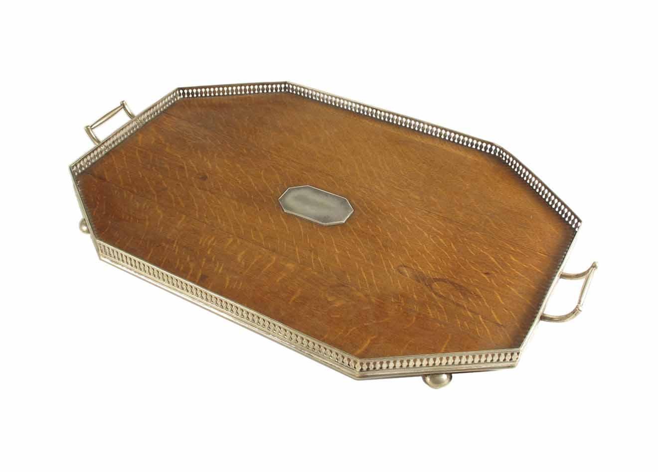 Appraisal: An oak and silver plated galleried two handle tray