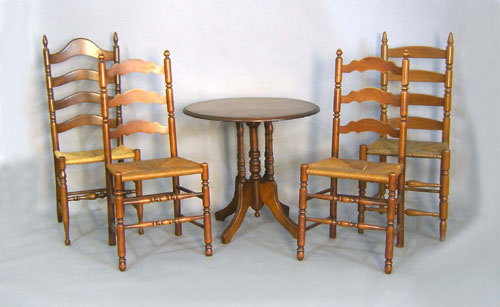 Appraisal: Four ladderback chairs together with a center table and end