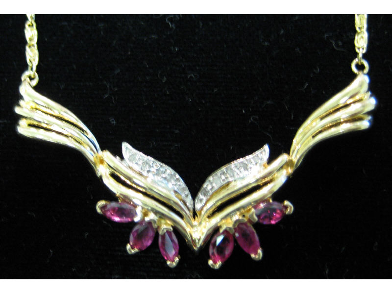 Appraisal: RUBY AND DIAMOND NECKLACE k yellow gold fluted design plaque