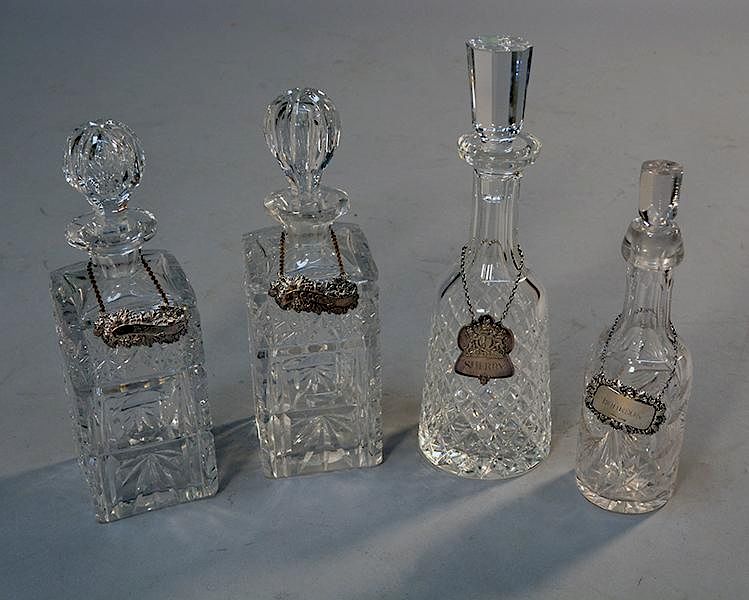 Appraisal: Four cut crystal decanters with silver labels Four cut crystal